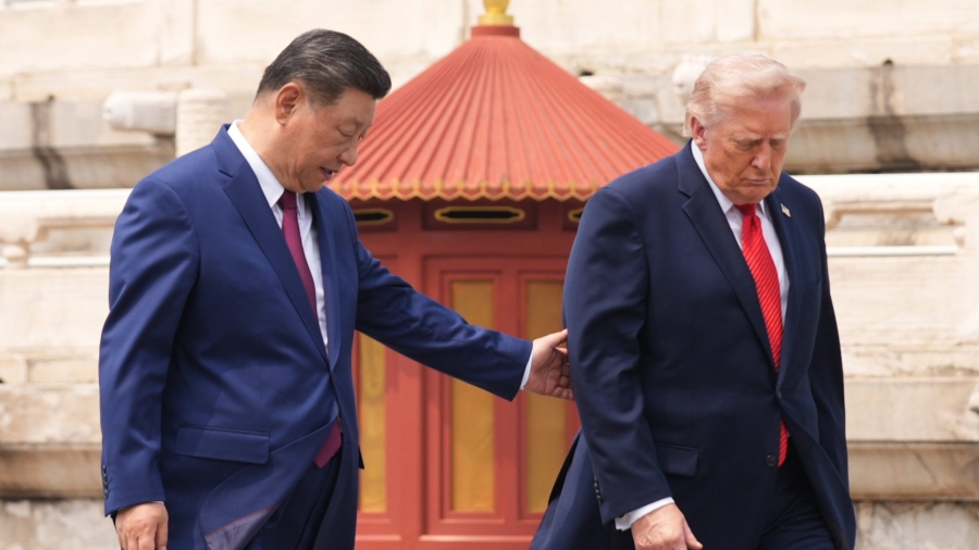 President Donald Trump, right, is assisted by Chinese President Xi Jinping at the Temple of Heaven on Thursday May 14, 2026, in Beijing. (AP Photo/Mark Schiefelbein)